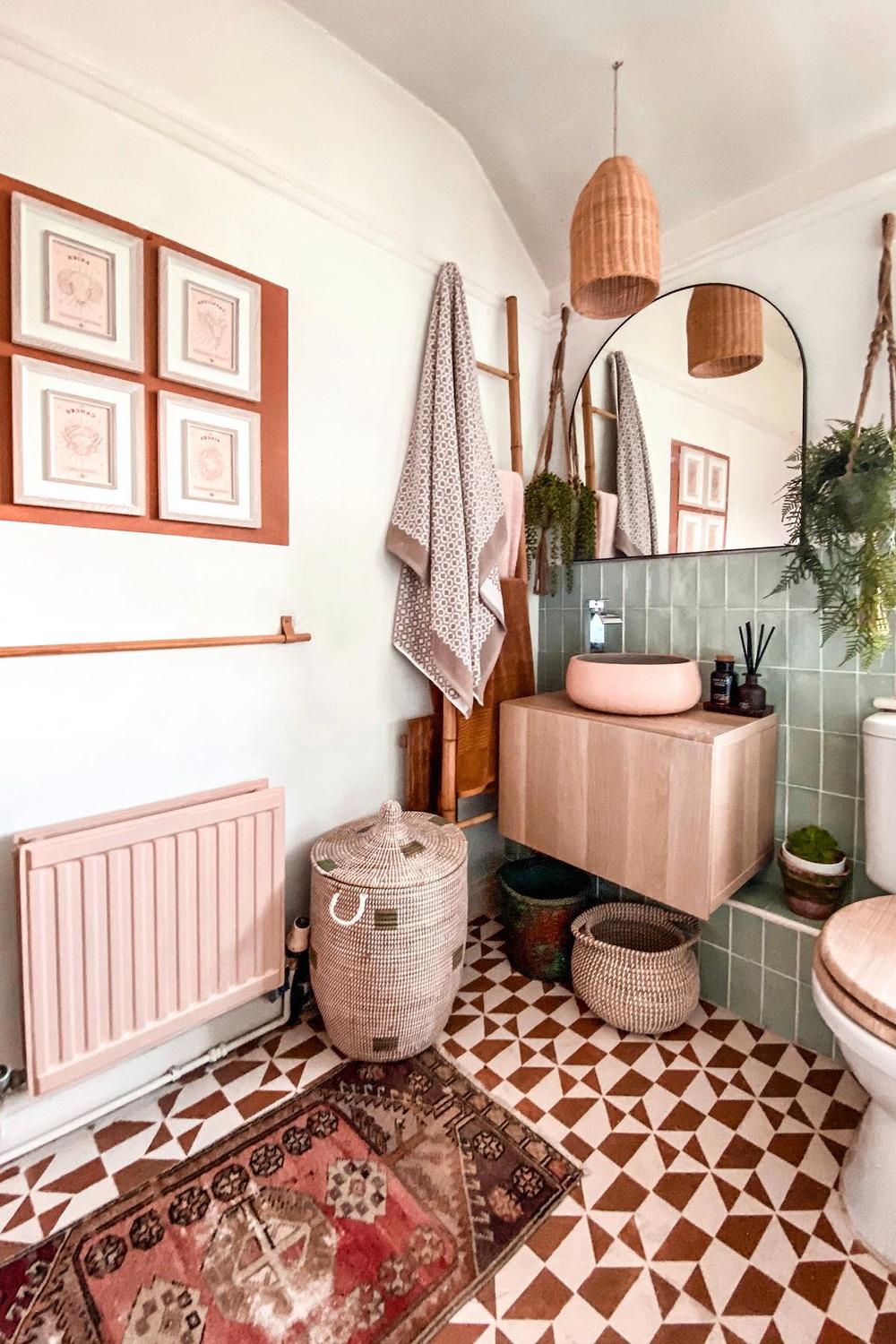 Stylish bohemian bathroom featuring lush greenery, soft pink accents, and minimalist decor.