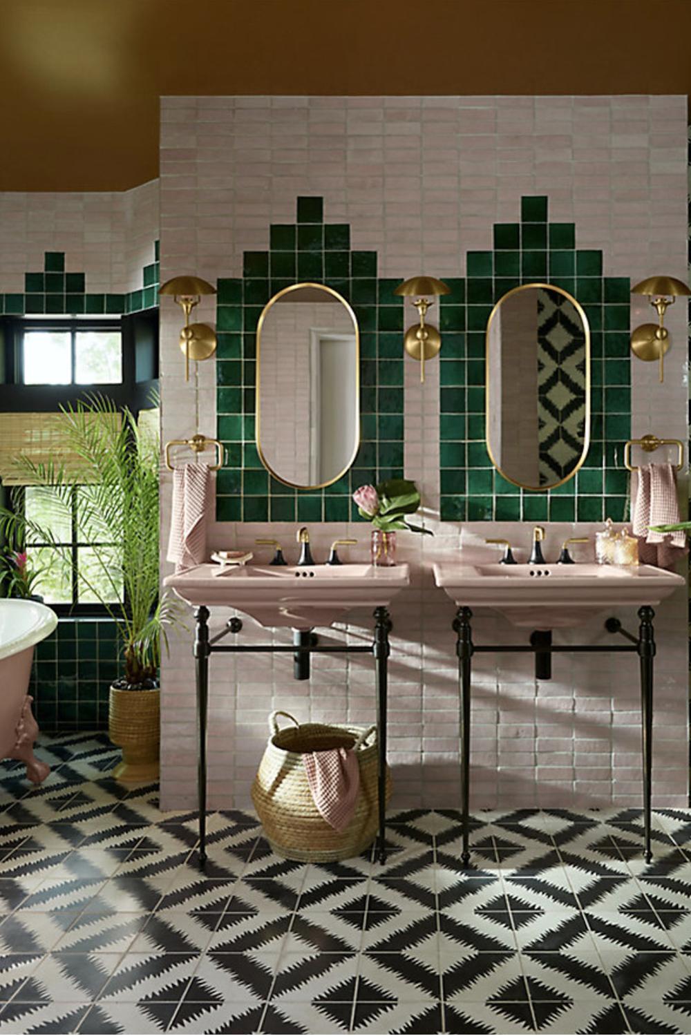 A beautifully designed boho chic bathroom featuring intricate green and pink wall tiles.