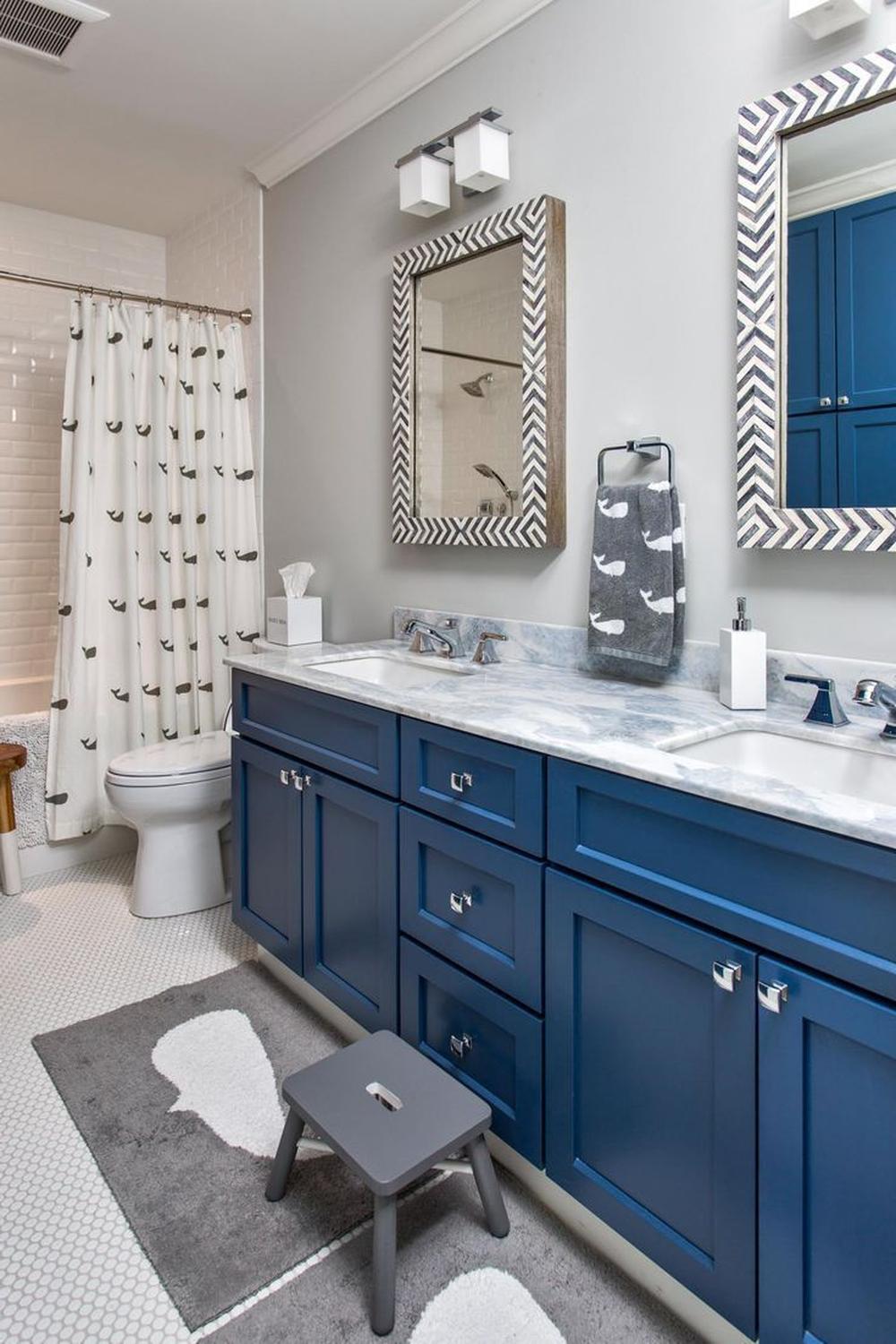 A vibrant blue and gray boys bathroom with a modern aesthetic