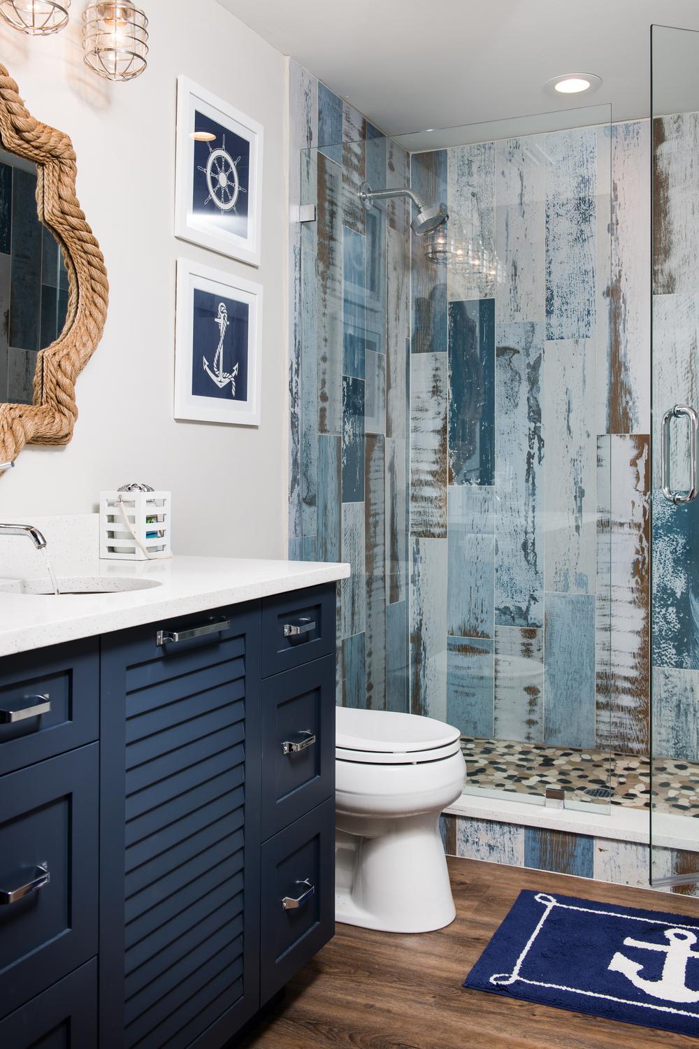 Coastal style boys bathroom featuring nautical themed decorations