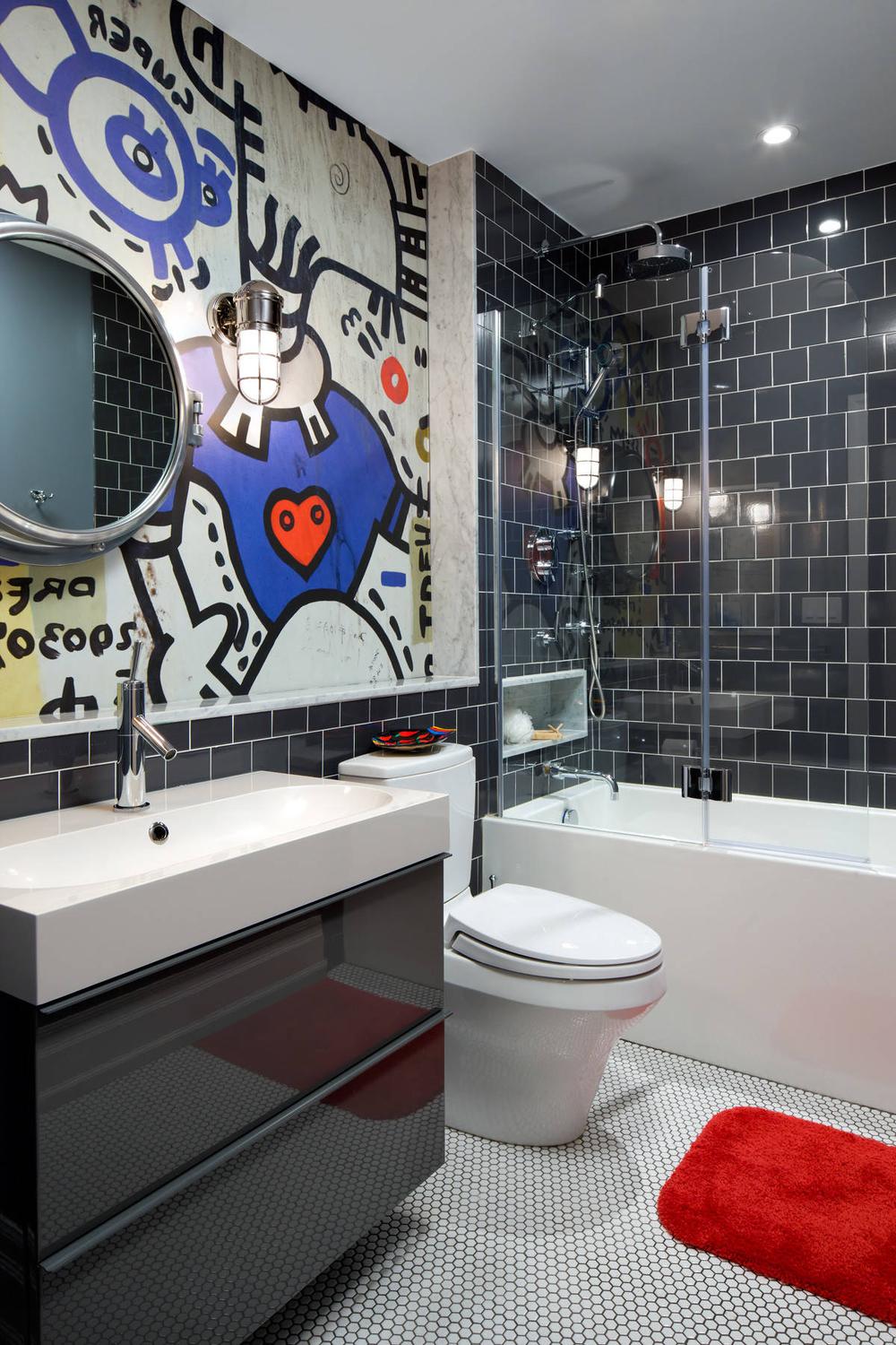 Modern boys' bathroom featuring graffiti art and sleek black fixtures.