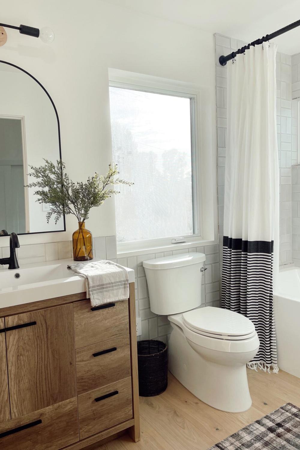 Modern minimalist boys bathroom with light wood and clean lines.
