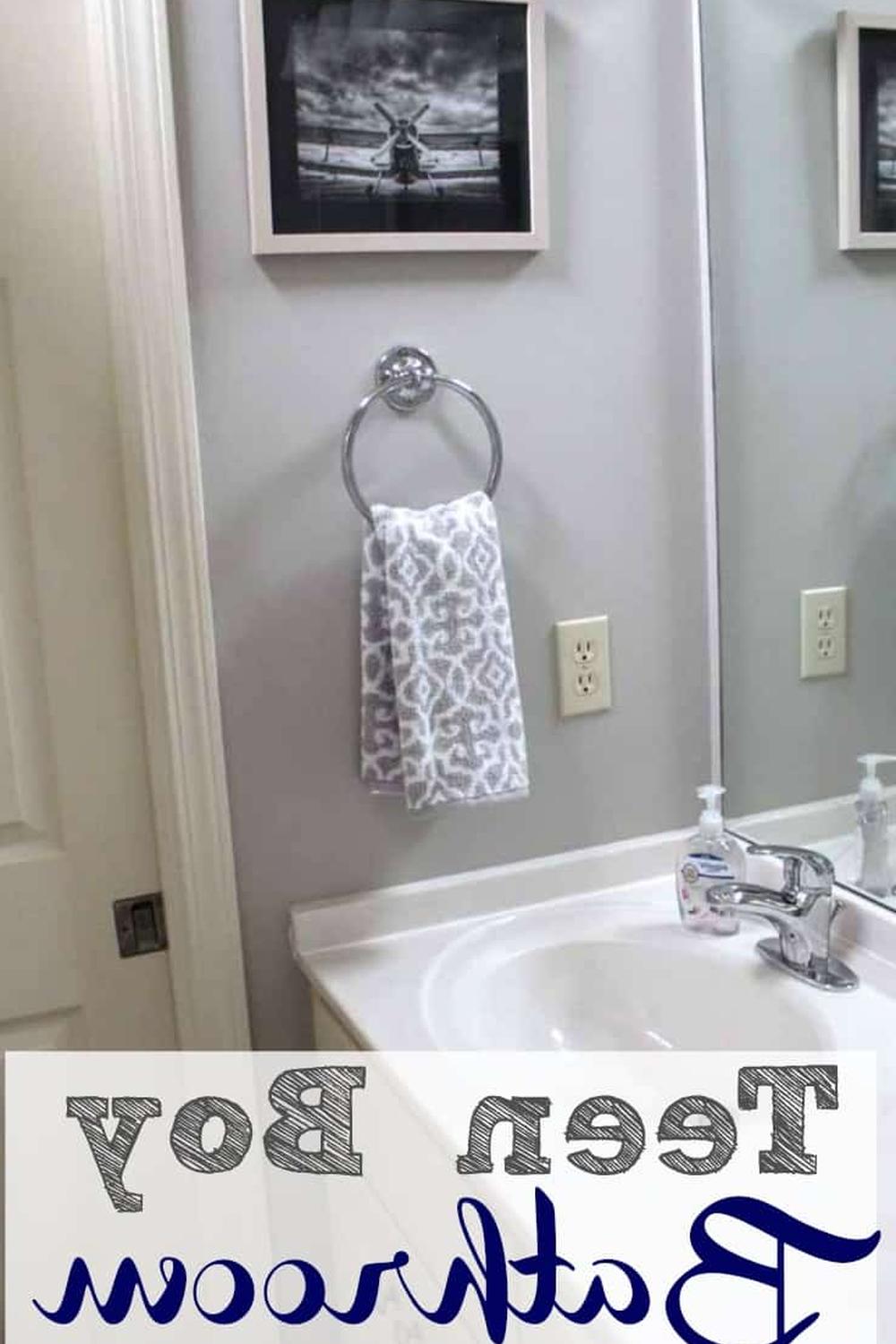 Well-organized boys bathroom with modern gray tones and playful art.