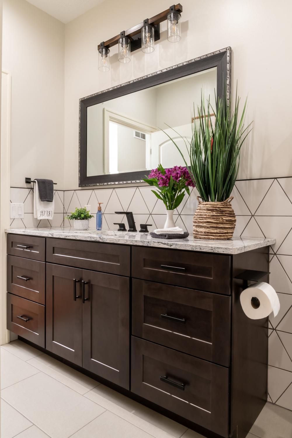 A Functional Dark Brown Vanity with a Light-Colored Countertop and Spacious Storage