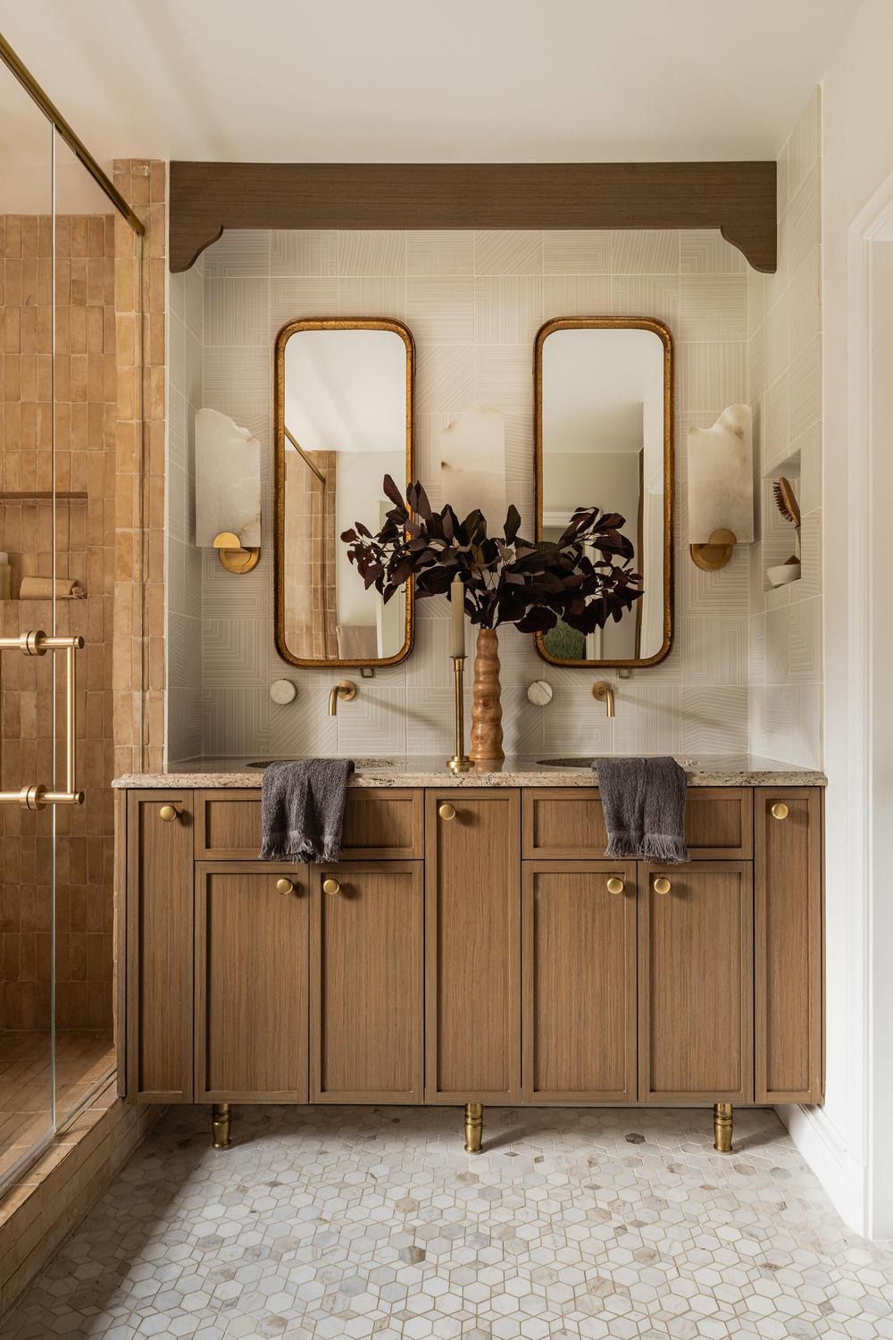 A Minimalist Brown Vanity with Unique Lighting Fixtures and Chic Mirrors