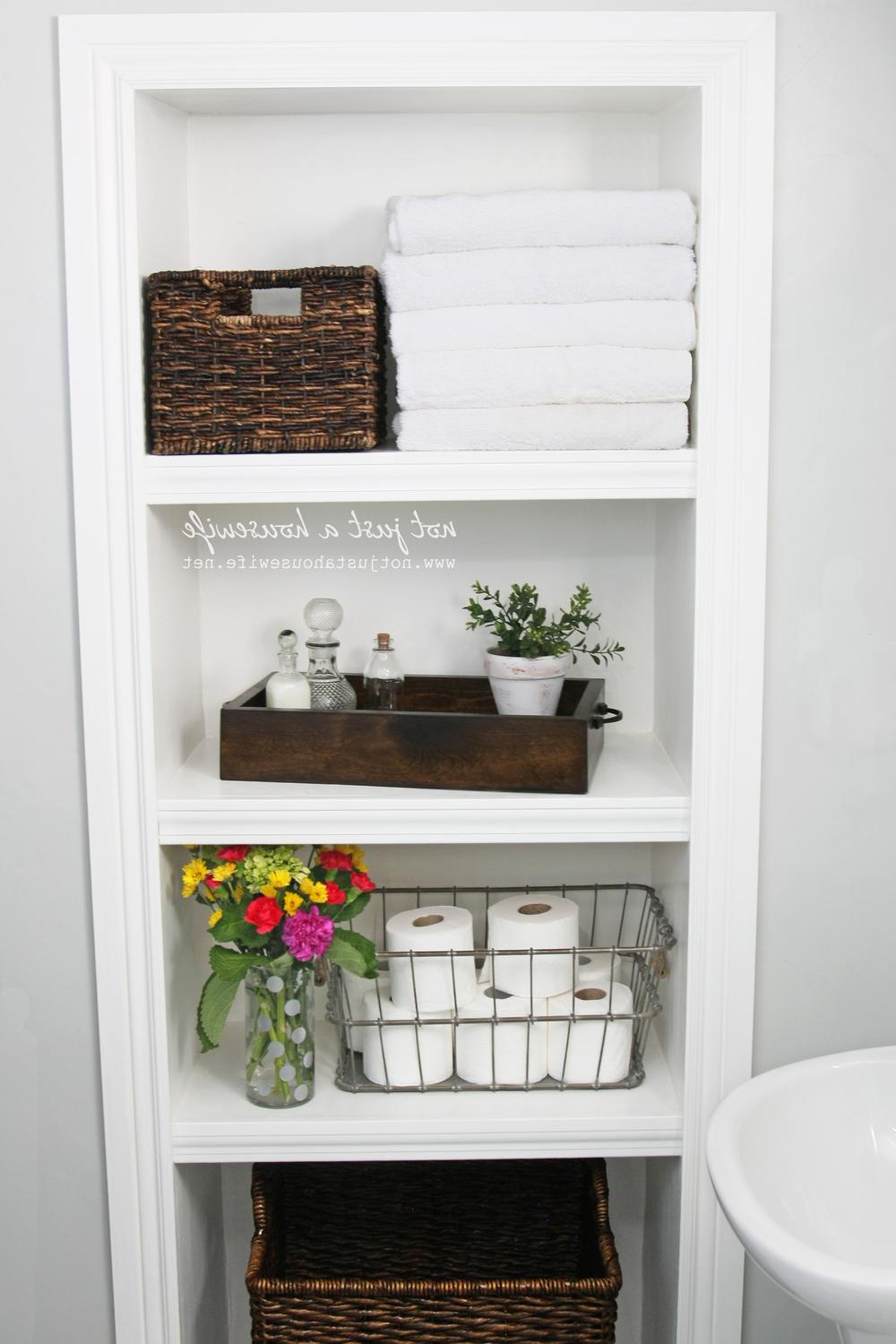 Stylish multi-tiered bathroom shelves with decorative elements showcasing vibrant flowers and organized toiletries.