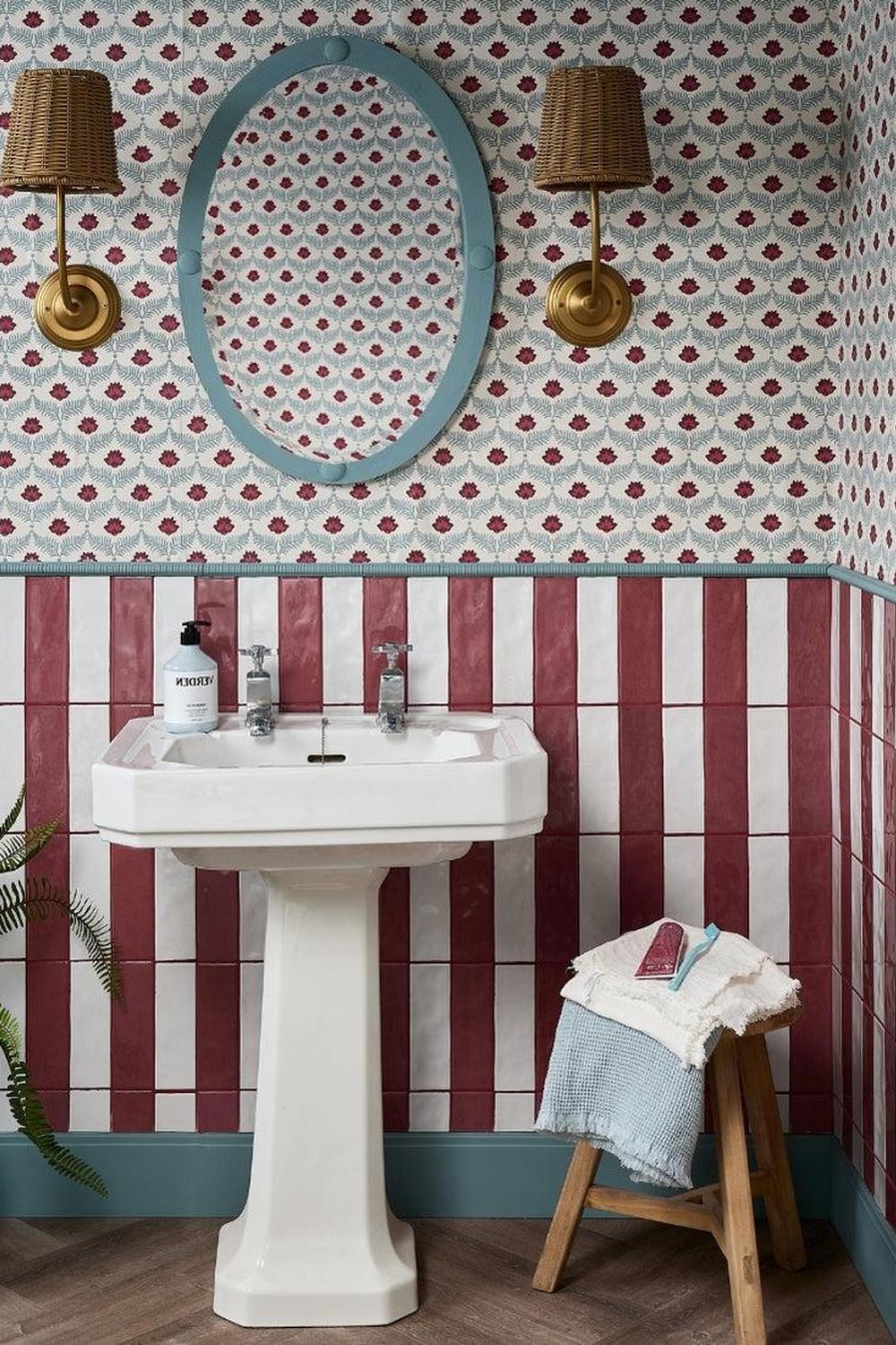 A bathroom design blending vintage and modern styles with burgundy tiles.