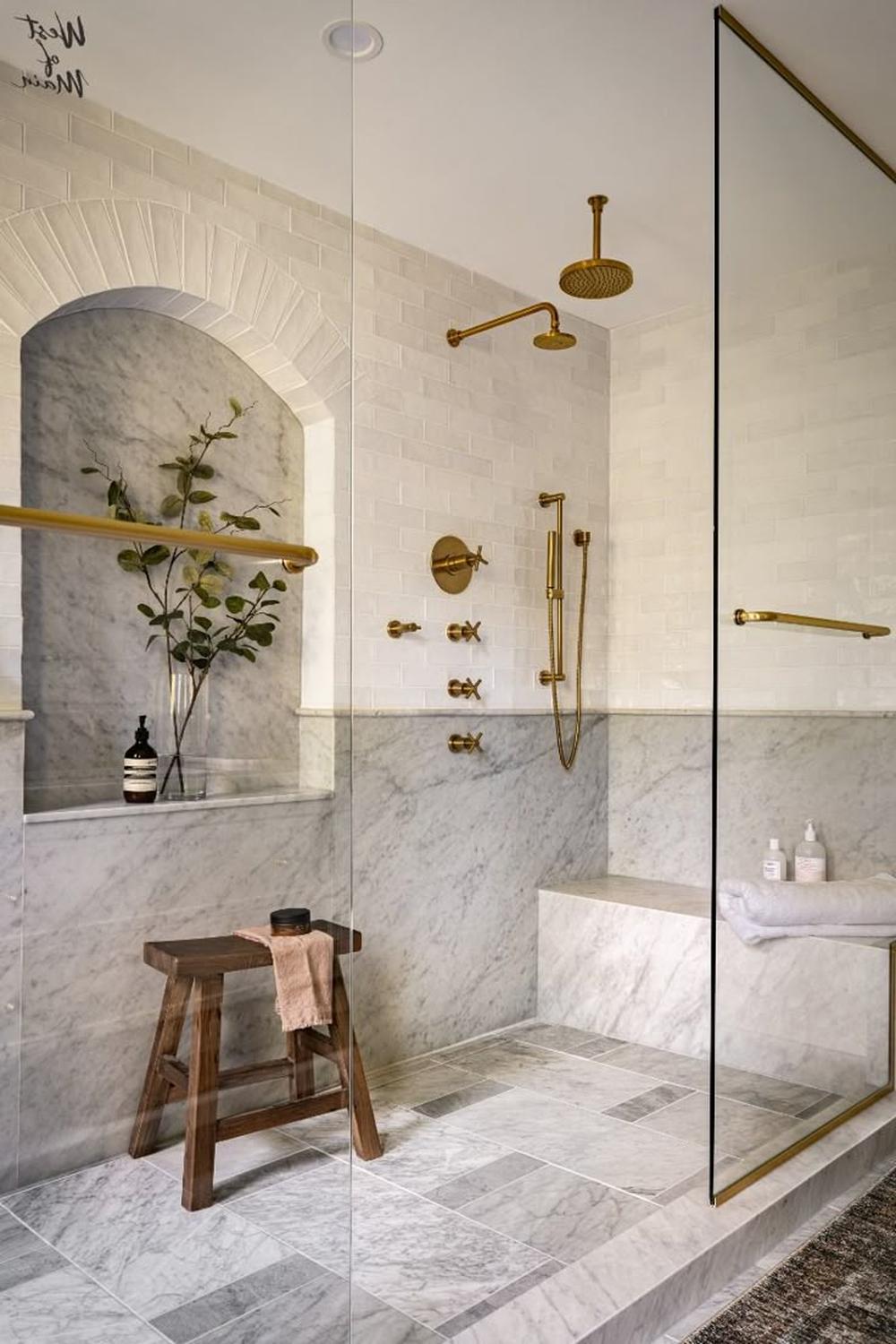 Luxurious bathroom featuring Carrara marble and elegant gold accents