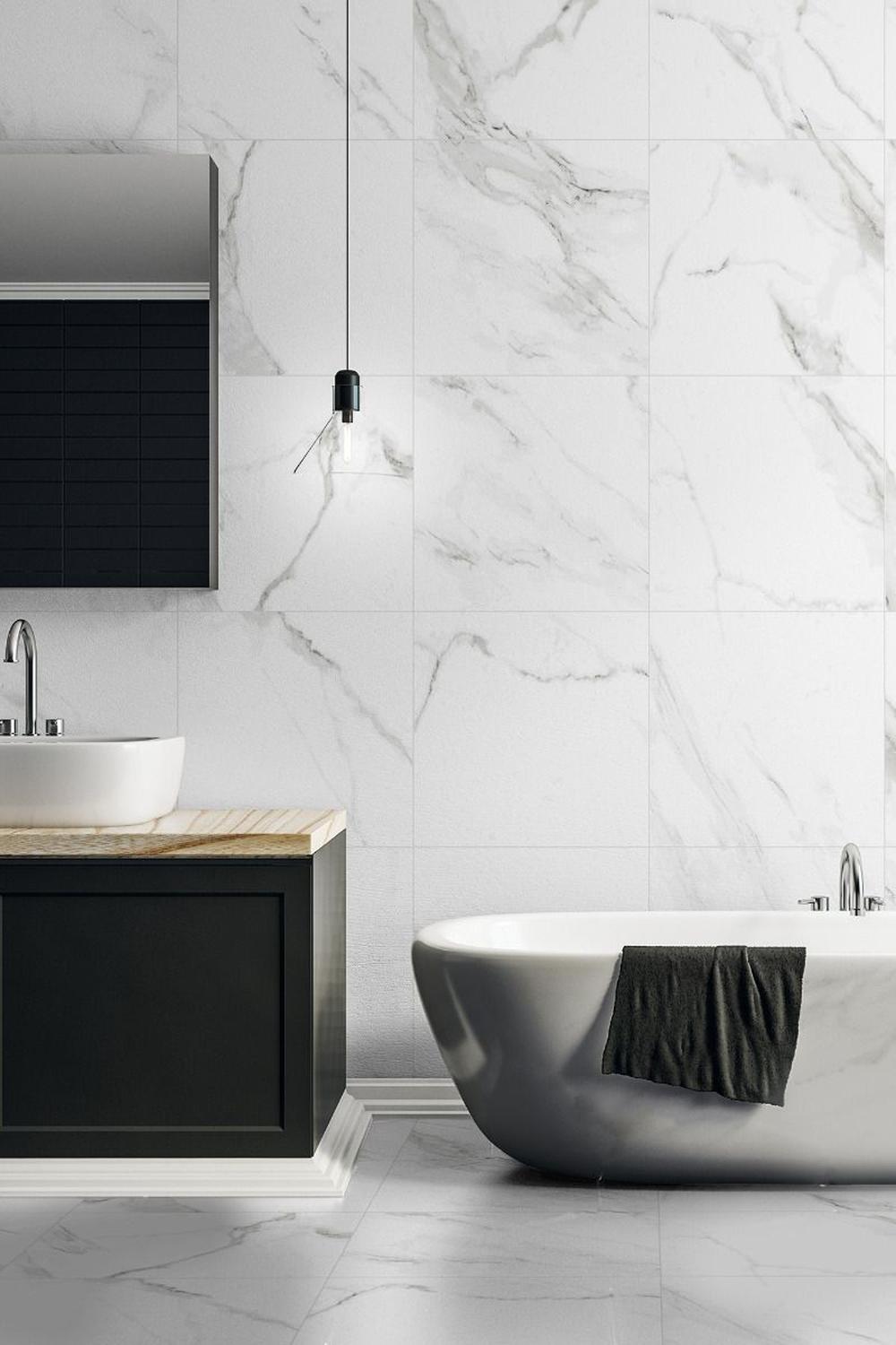 Modern bathroom highlighting design with Carrara marble and focused lighting