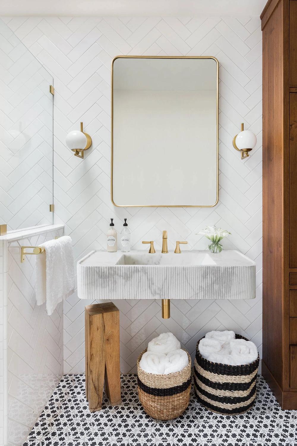 Refreshing white bathroom with subtle accents and luxurious marble