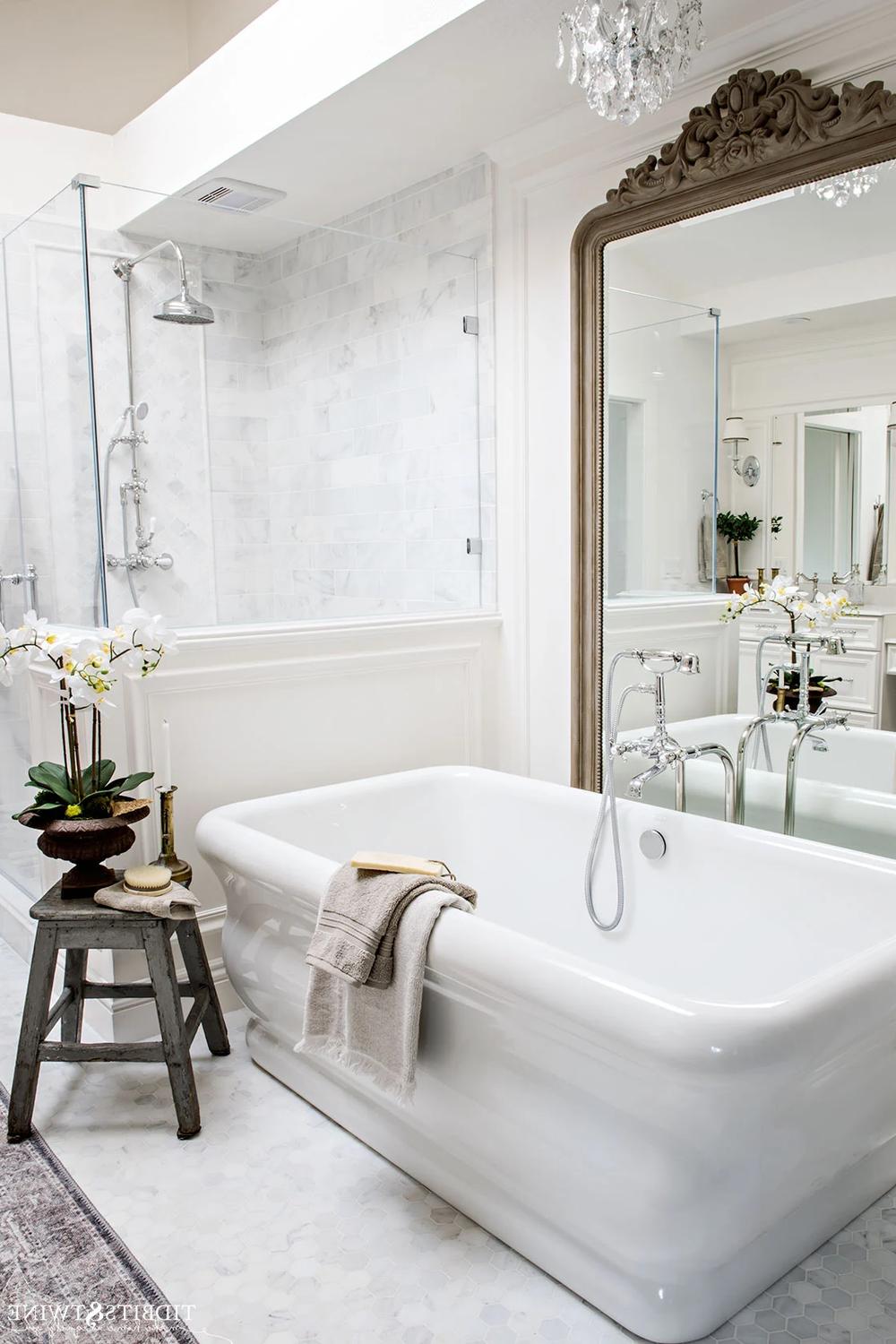 Soothing bathroom design featuring lush Carrara marble and simple accessories