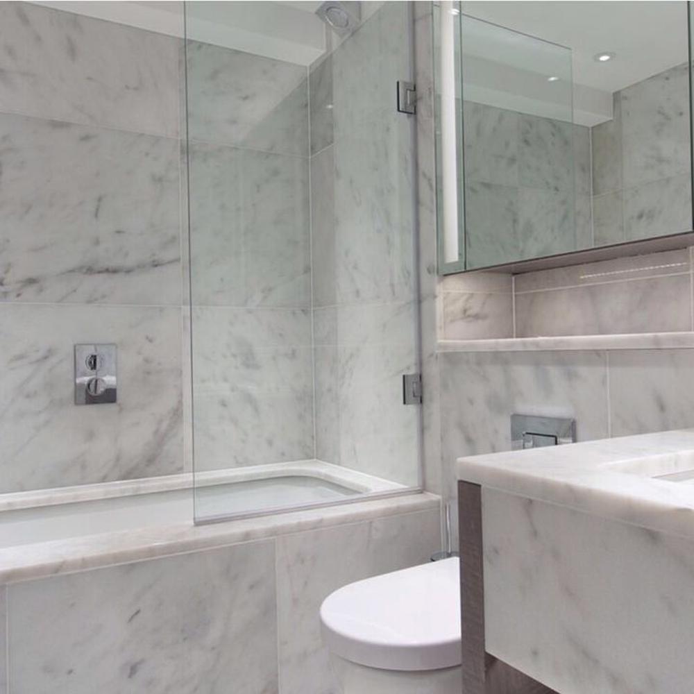 Exceptional bathroom design with elegant details and Carrara marble