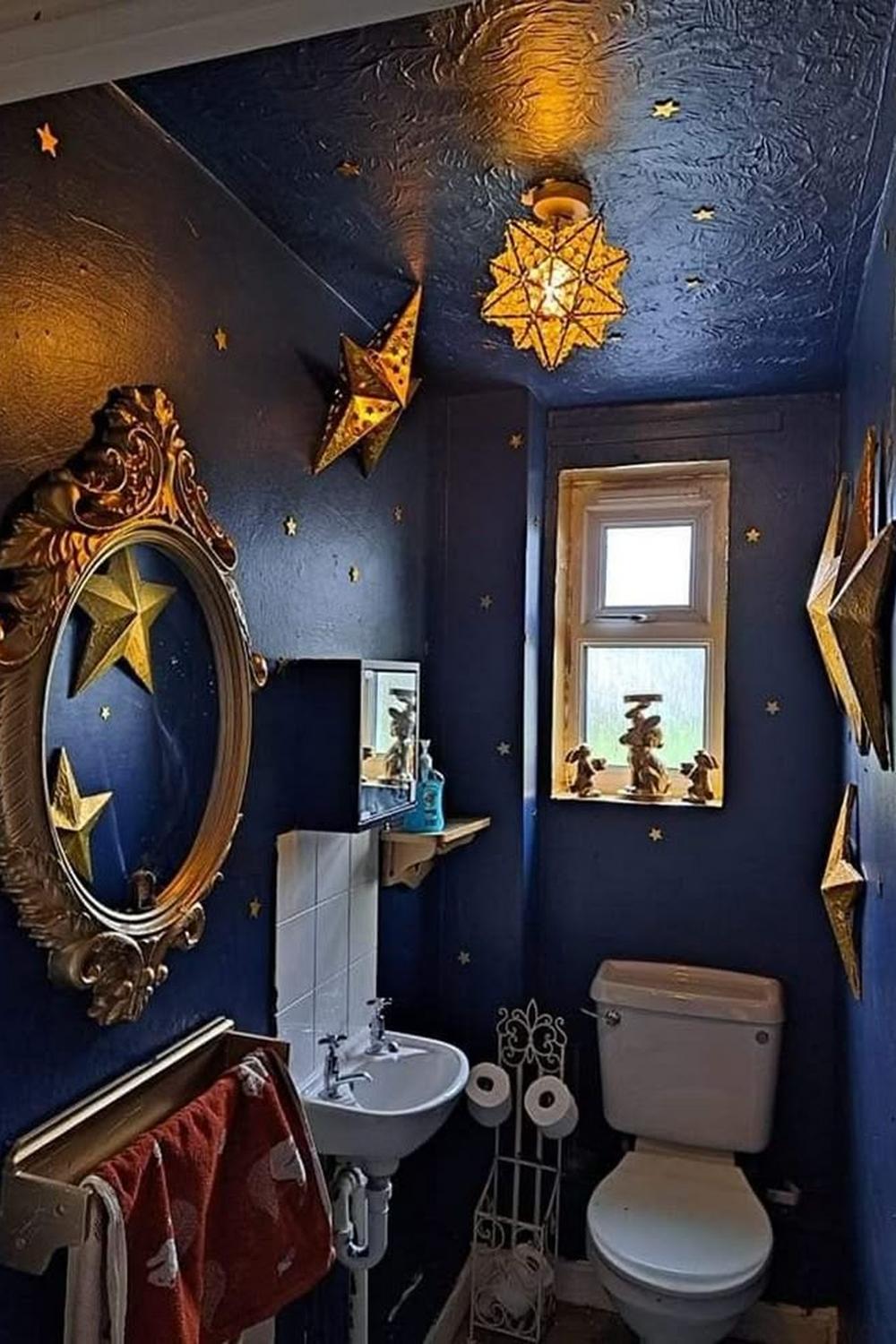 Celestial chandelier with starry decor in a stylish bathroom.
