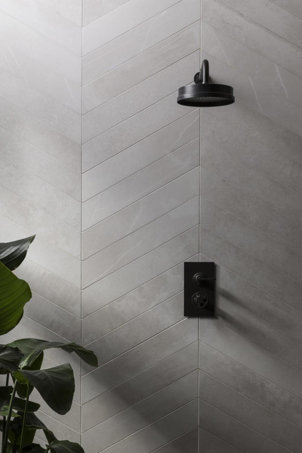 Modern bathroom featuring different shades of gray chevron tile.
