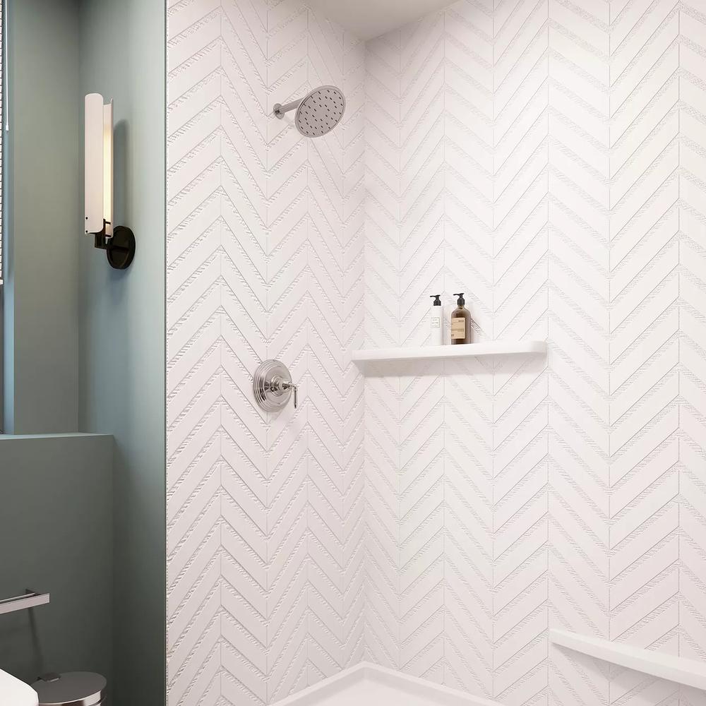 Modern shower area with striking chevron tiles.