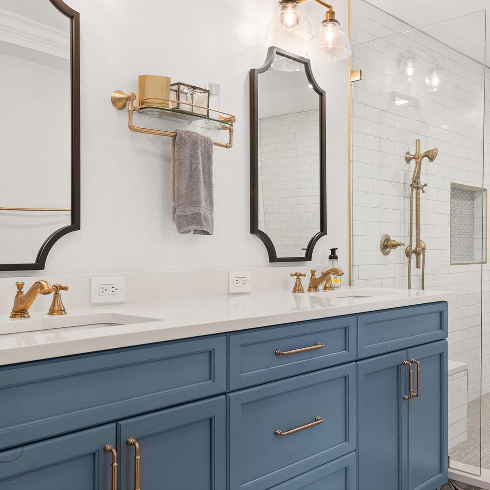 Luxurious navy bathroom featuring dual sinks and glamorous fixtures.
