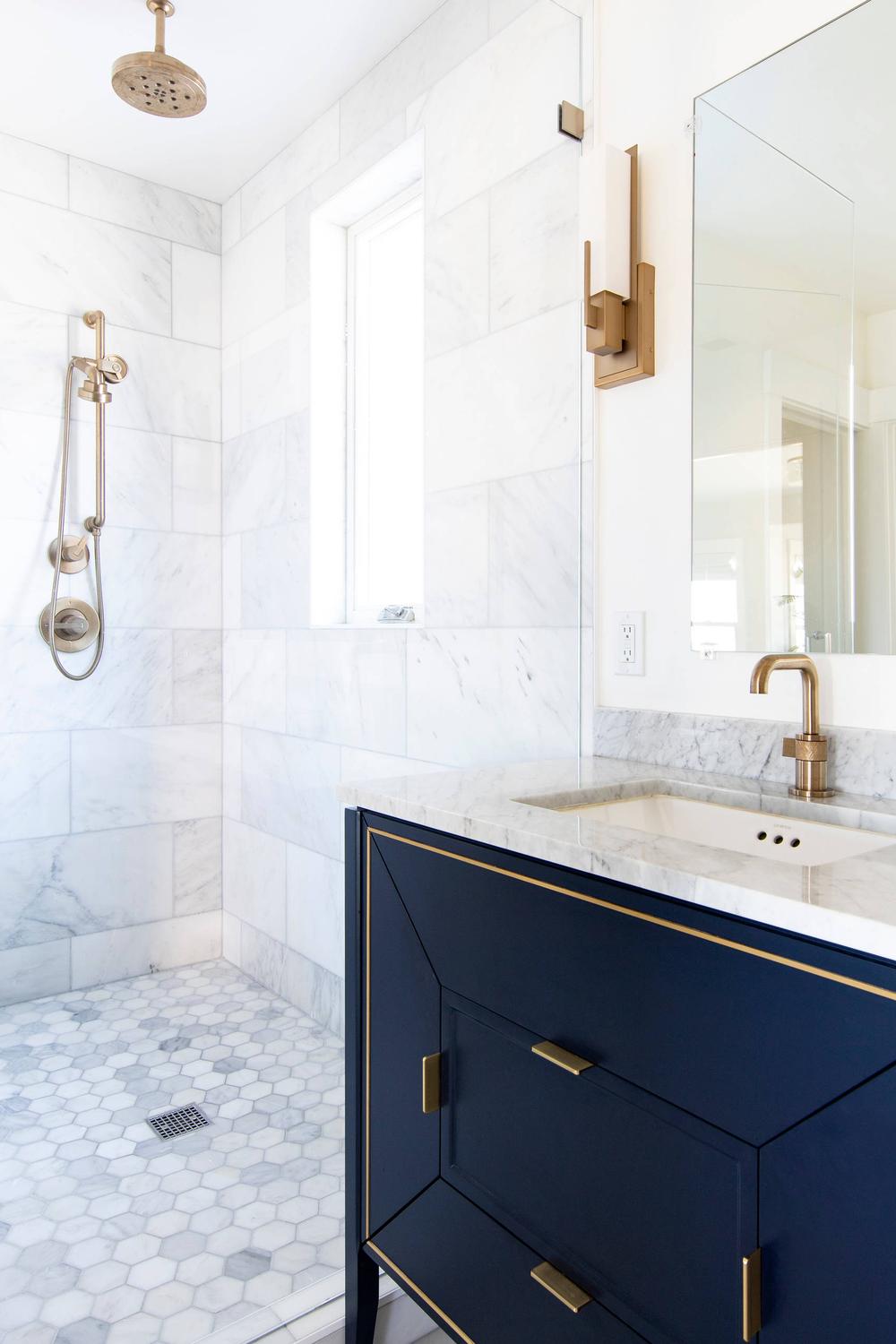 Spa-like navy bathroom featuring elegant fixtures and a calming ambiance.
