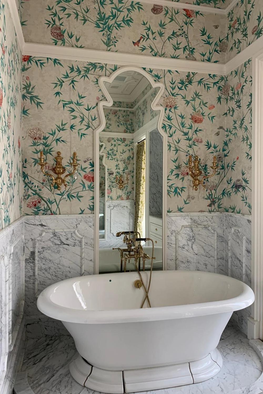 Exotic floral-themed Chinoiserie wallpaper in vibrant greens and pinks complemented by luxurious fixtures in a modern bathroom.