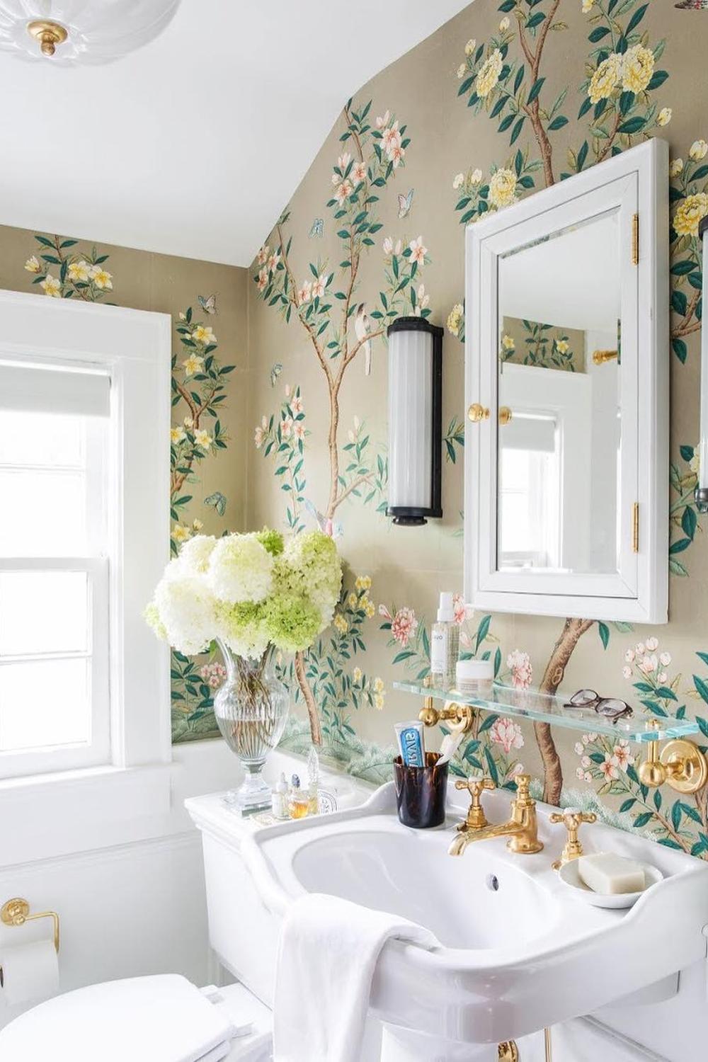 Pastel-themed chinoiserie wallpaper adorned with floral motifs in a beautifully designed bathroom with vintage accents.