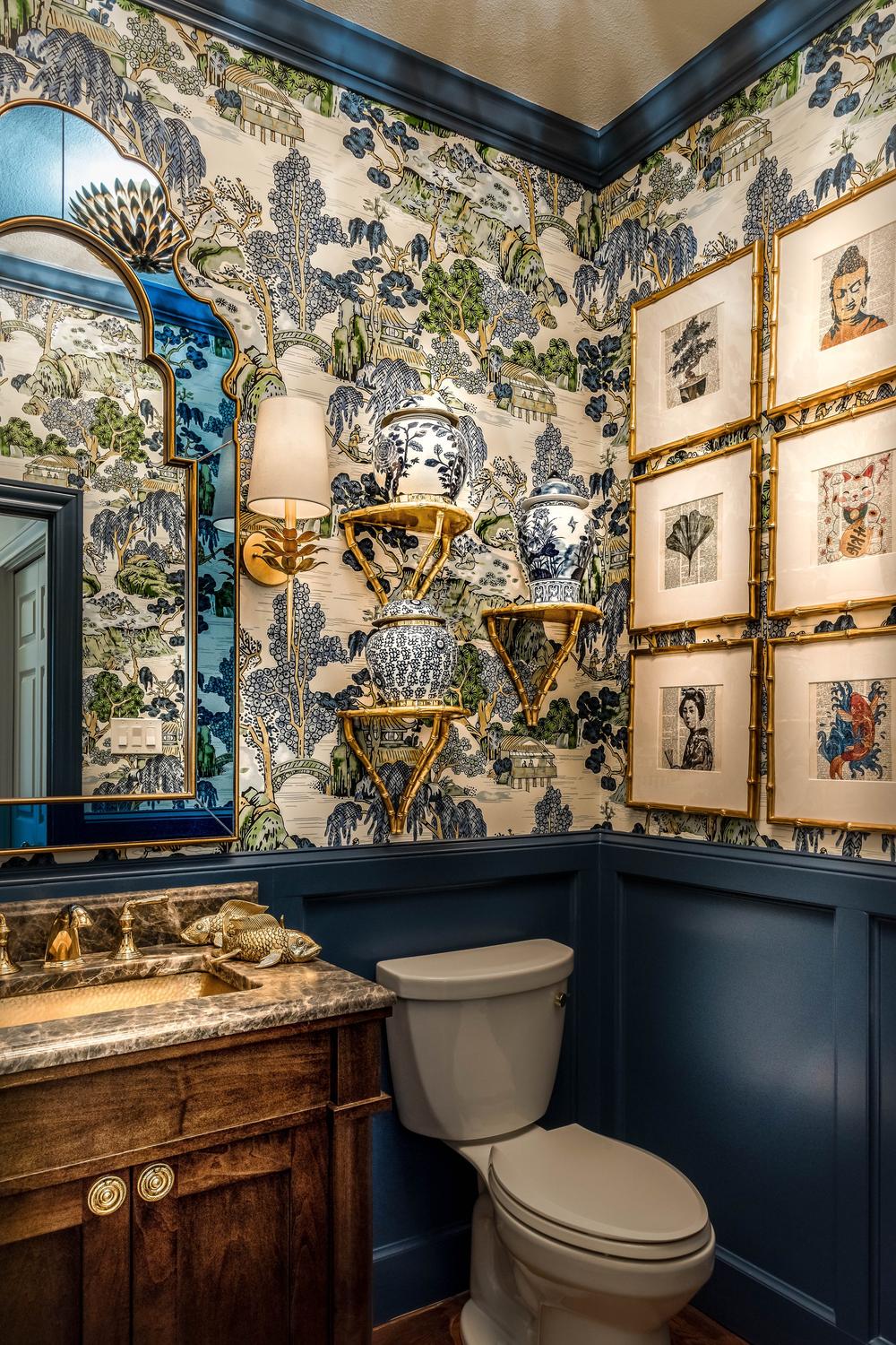 Botanical-inspired chinoiserie wallpaper with deep blue and green tones, elegantly styled in a modern bathroom.