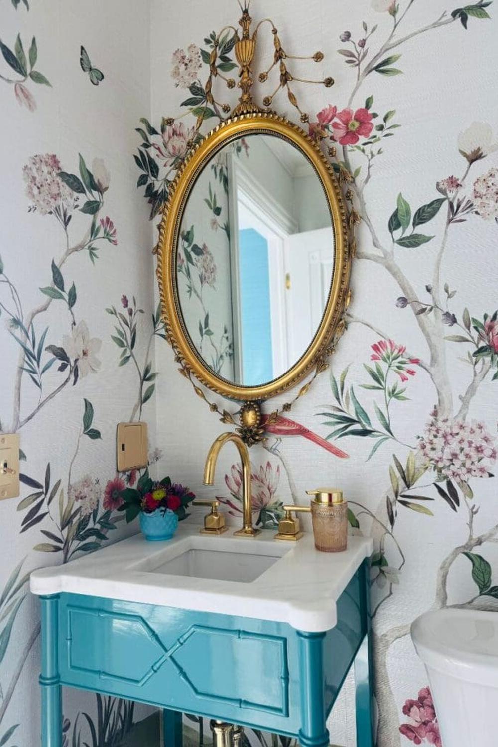 Vibrant floral Chinoiserie wallpaper with a turquoise vanity, creating a lively and stylish bathroom ambiance.