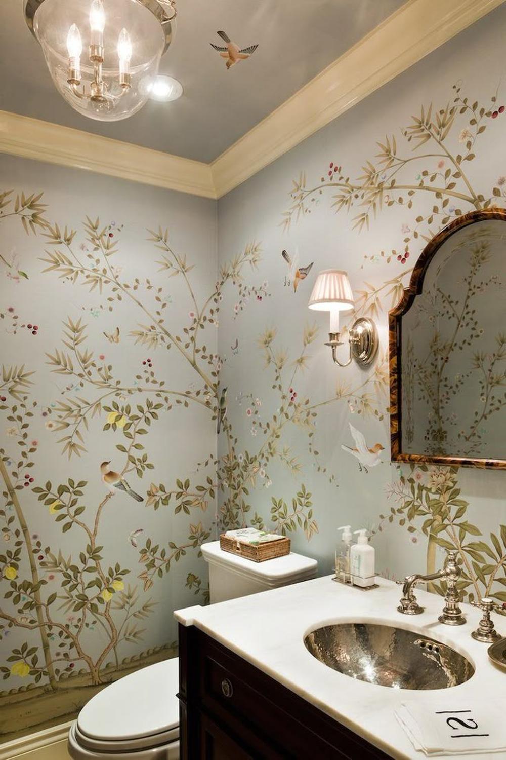 Chinoiserie wallpaper adorned with soft blue designs featuring intricate branches and leaves creating a harmonious ambiance in a bathroom.