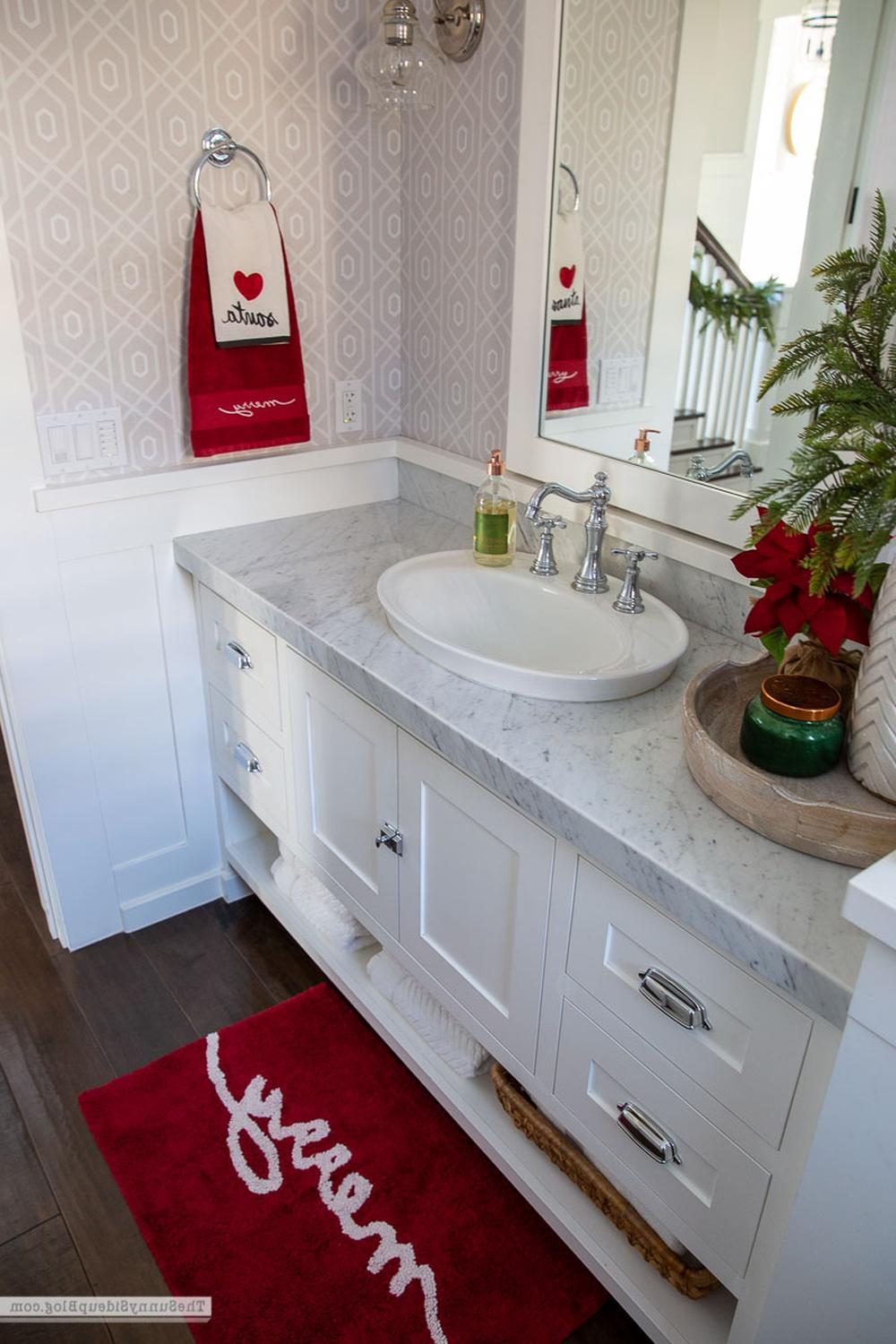 A charming bathroom showcasing classic red and white decorations for holiday vibes.