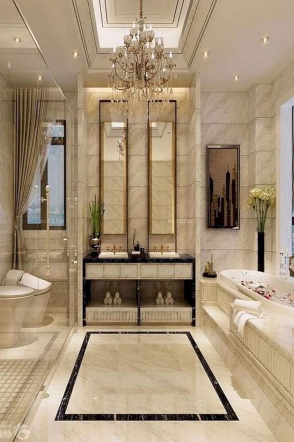 Sophisticated bathroom featuring beige and cream tones with luxurious materials and decorative lighting.