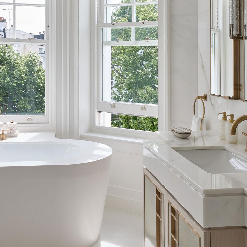 Contemporary bathroom with elegant white bathtub and wooden cabinetry enhancing warmth and style.