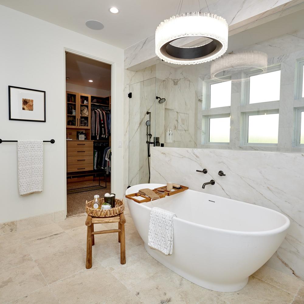 Stylish bathroom featuring luxurious marble and artistic lighting that enhances an elegant atmosphere.
