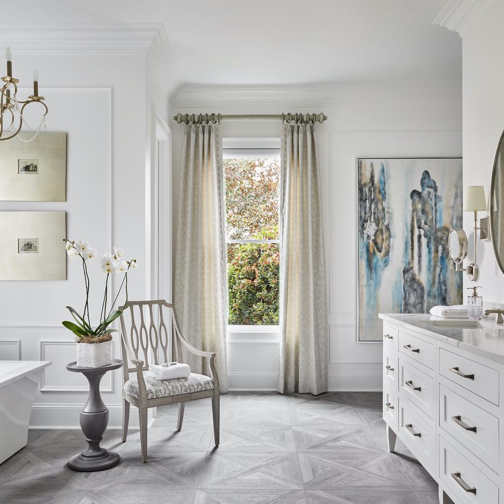 Sophisticated bathroom design featuring light neutral tones and decorative elements enhancing serenity and elegance.