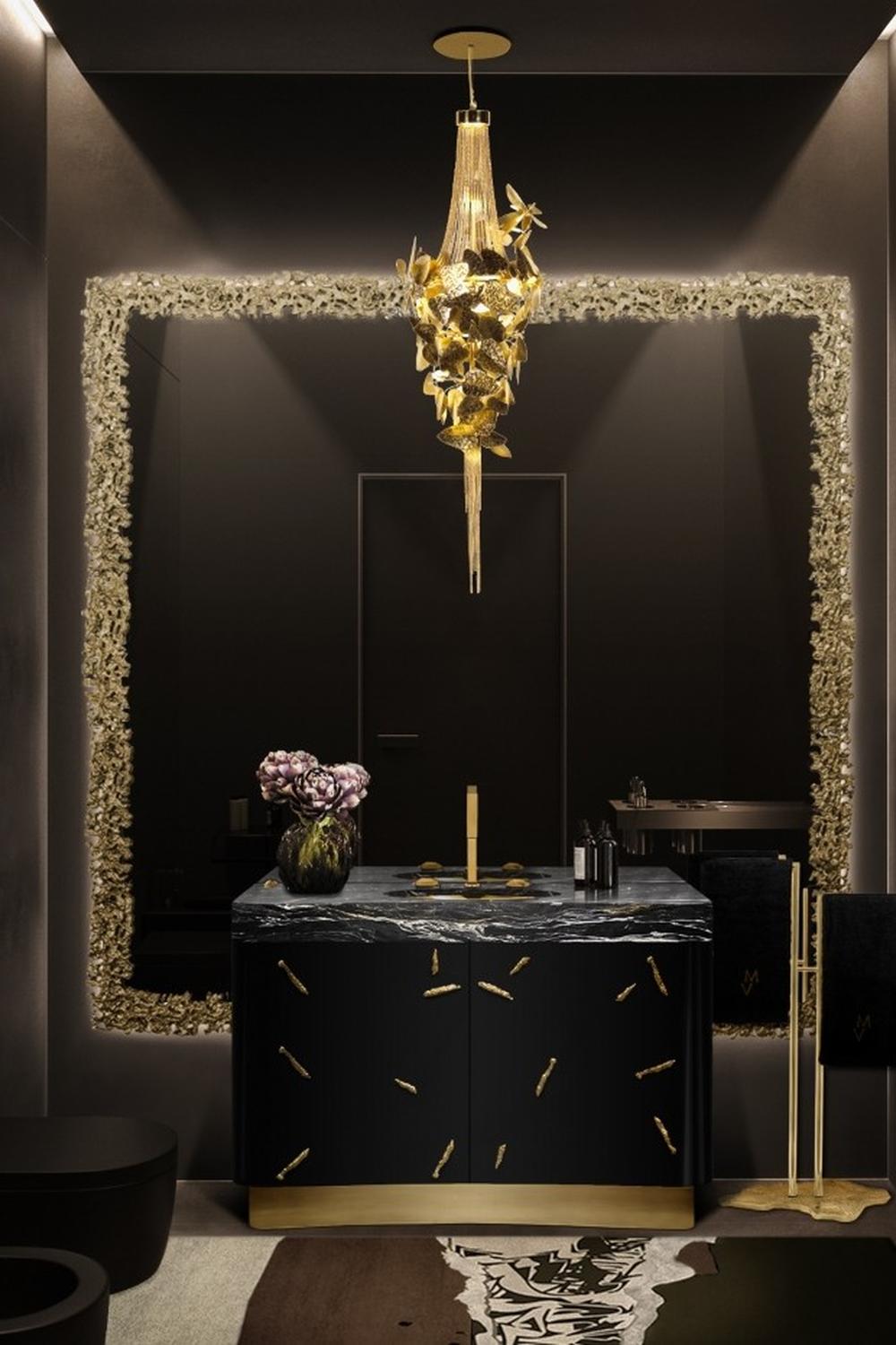 Sophisticated bathroom featuring gold and black tones with a chandelier creating an opulent atmosphere.
