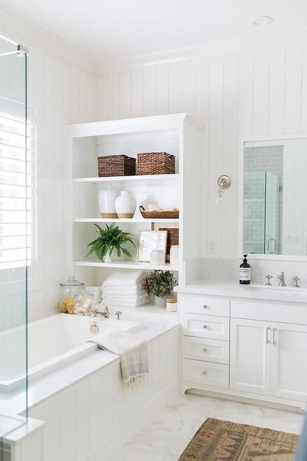Bright and functional bathroom design showcasing white tones, elegant accents, and plush textiles for a luxurious feel.