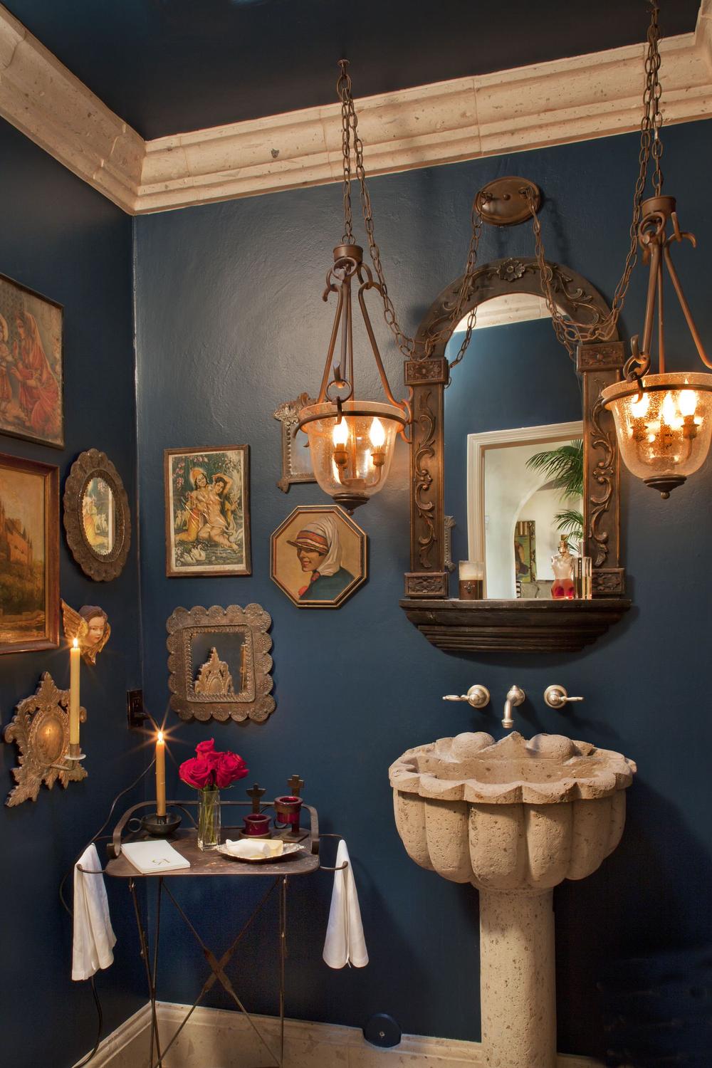 Cozy colonial bathroom featuring ornate lighting and stone pedestal sink.