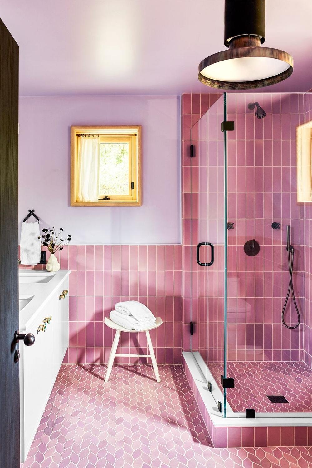 Charming bathroom with playful pink tiles and sleek modern fixtures.