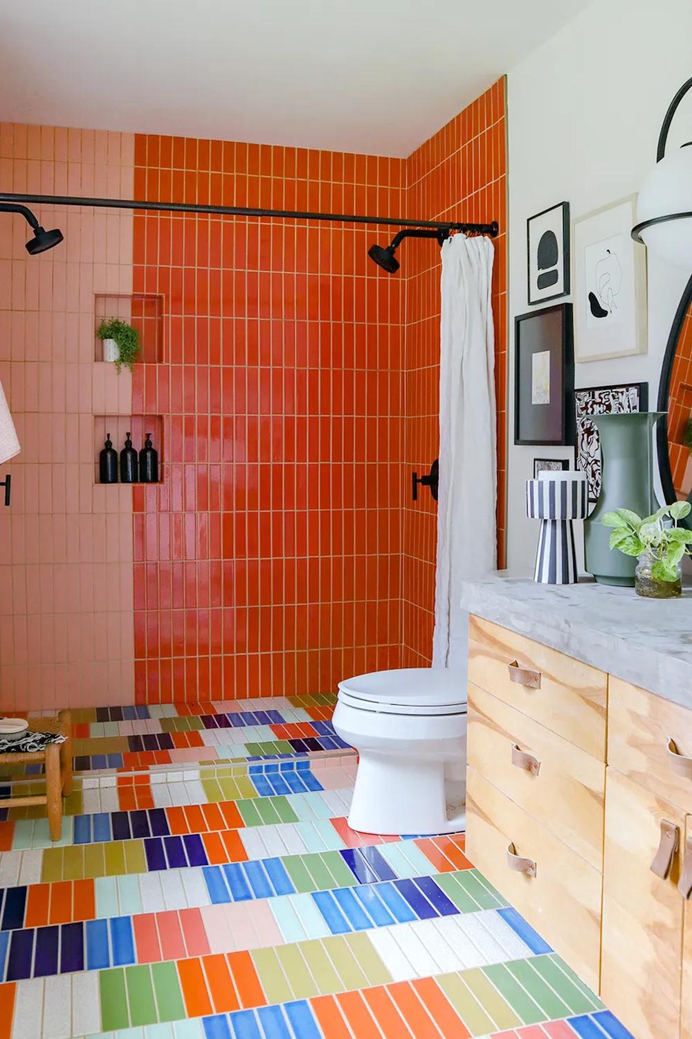 Lively bathroom showcasing a mix of orange and peach tiles with playful design elements.