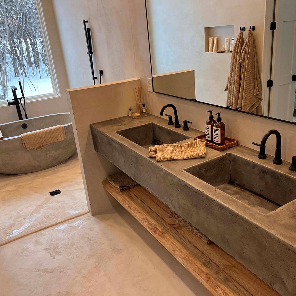 Robust Concrete Vanity with Double Sinks featuring integrated sinks and amber glass accessories.