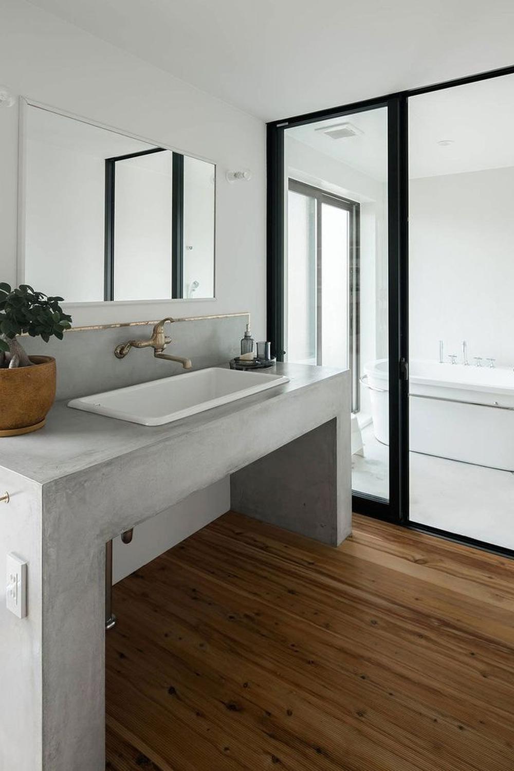 Simple Concrete Vanity with Gold Accents showcasing smooth surfaces and stylish fixtures.
