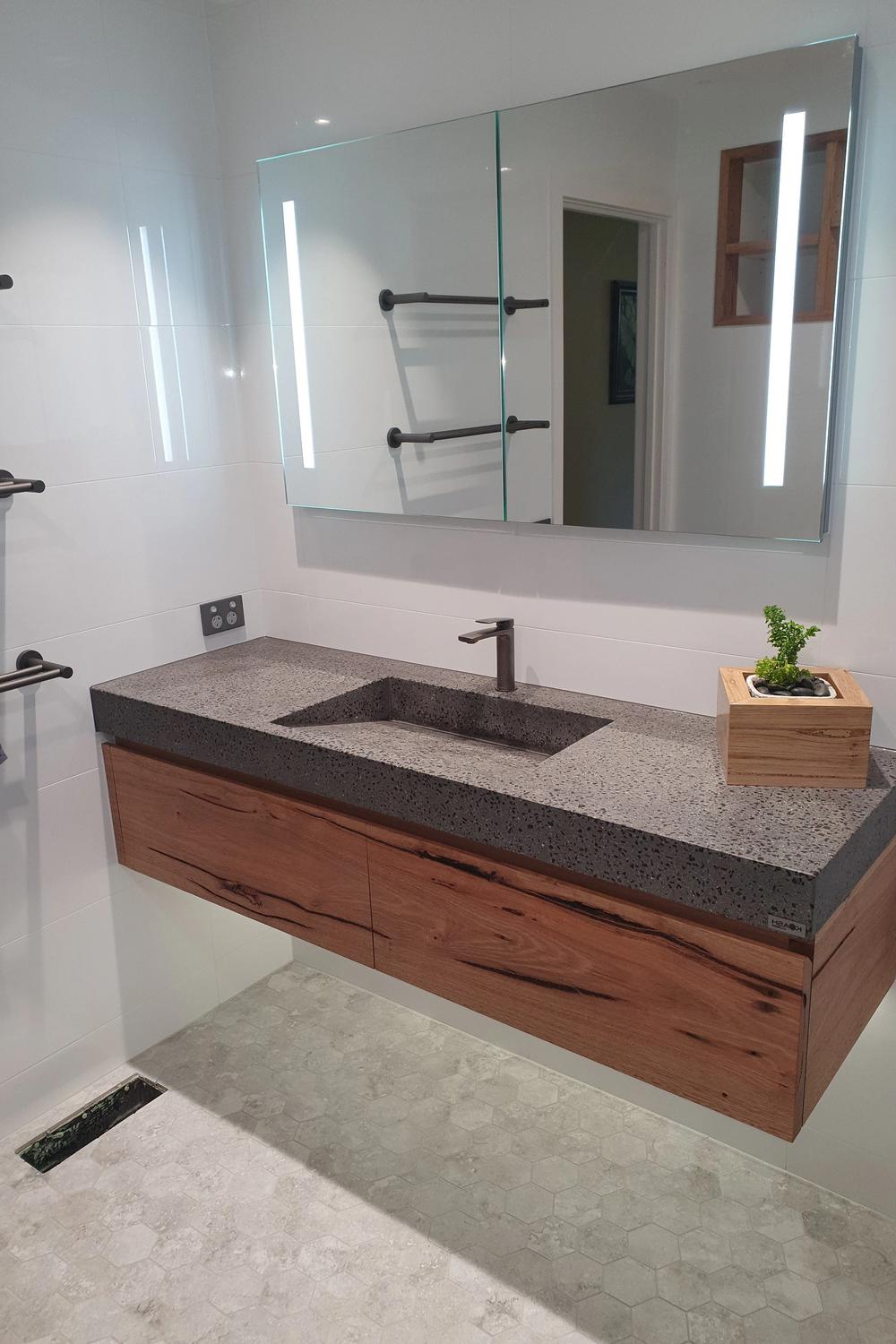 Monochromatic Vanity Design with a Touch of Nature featuring sleek lines and potted plant accents.