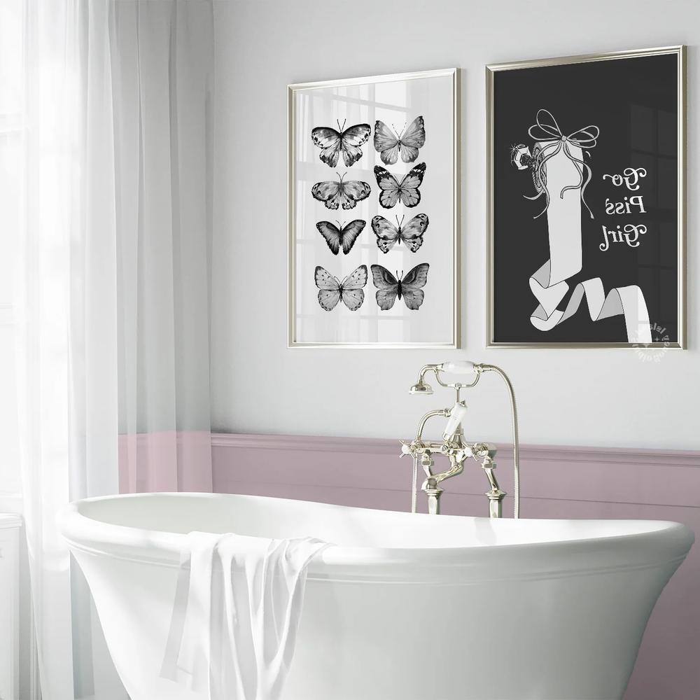 A classic freestanding bathtub surrounded by elegant decor and wall art.