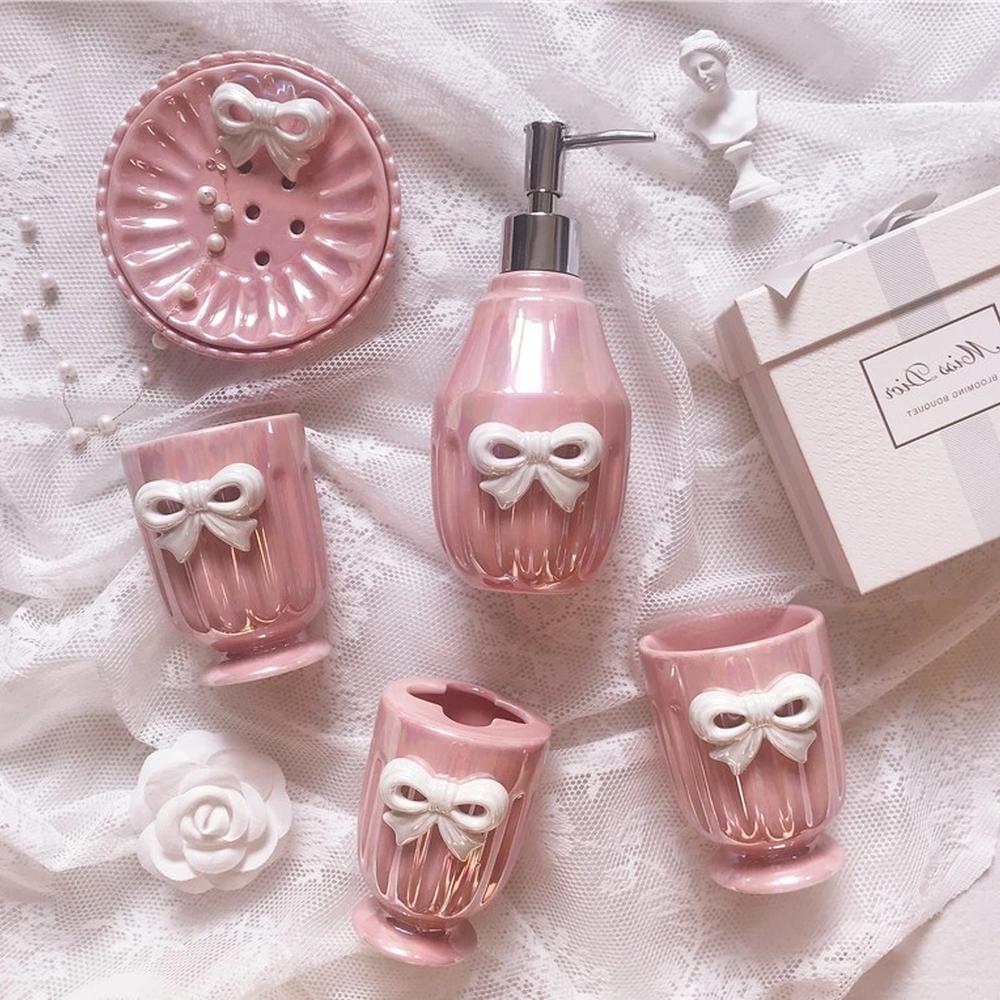 A beautifully arranged set of coquette-themed bathroom accessories.