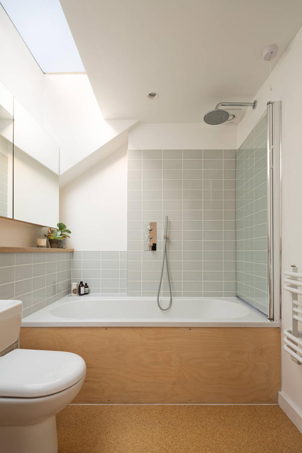 Minimalist bathroom design with light brown cork flooring and integrated wooden features