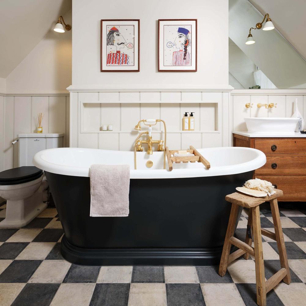 Stylish cottage bathroom with a black and white color scheme and elegant fixtures.