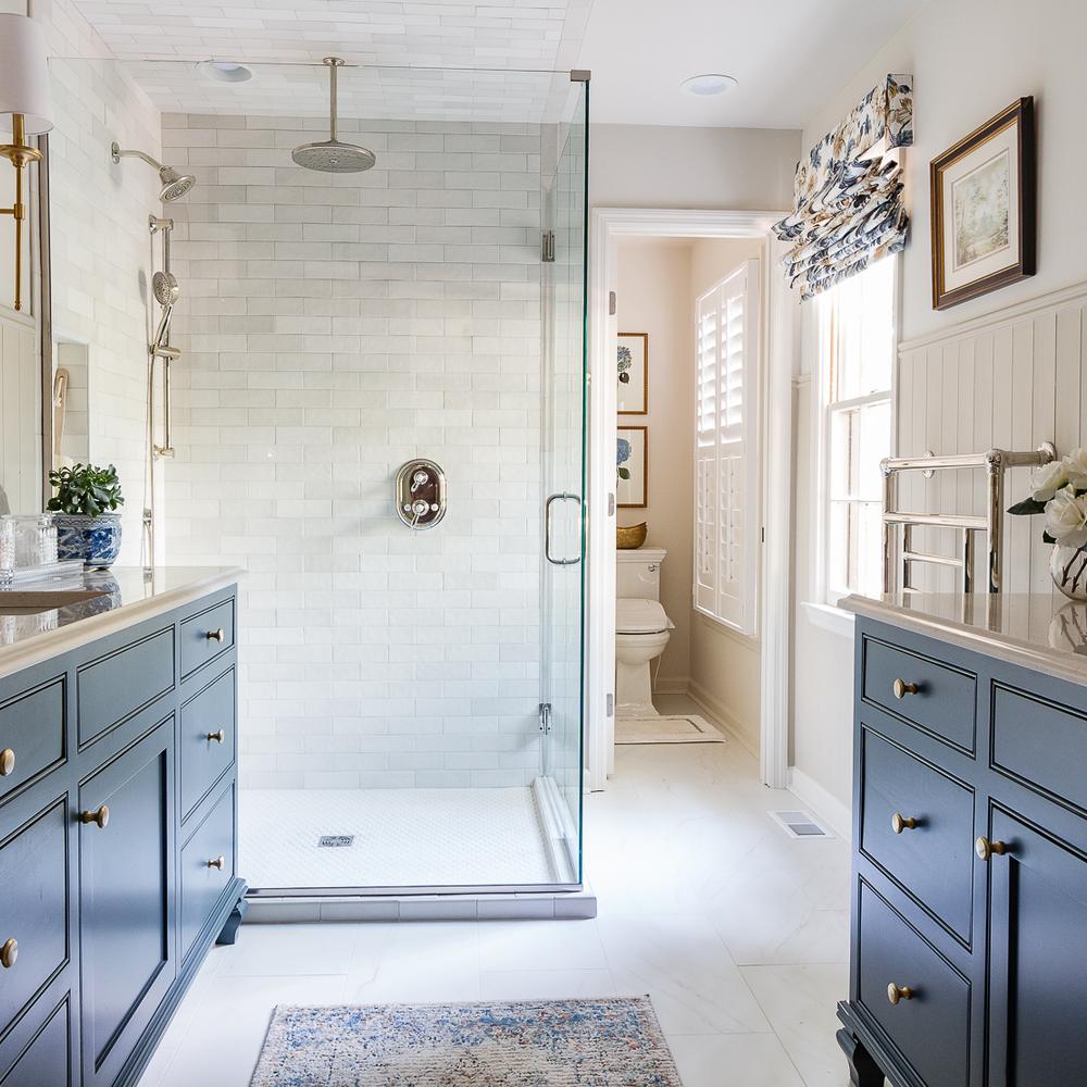 Inviting and calming cottage bathroom showcasing light blue cabinetry with nature-inspired accents.