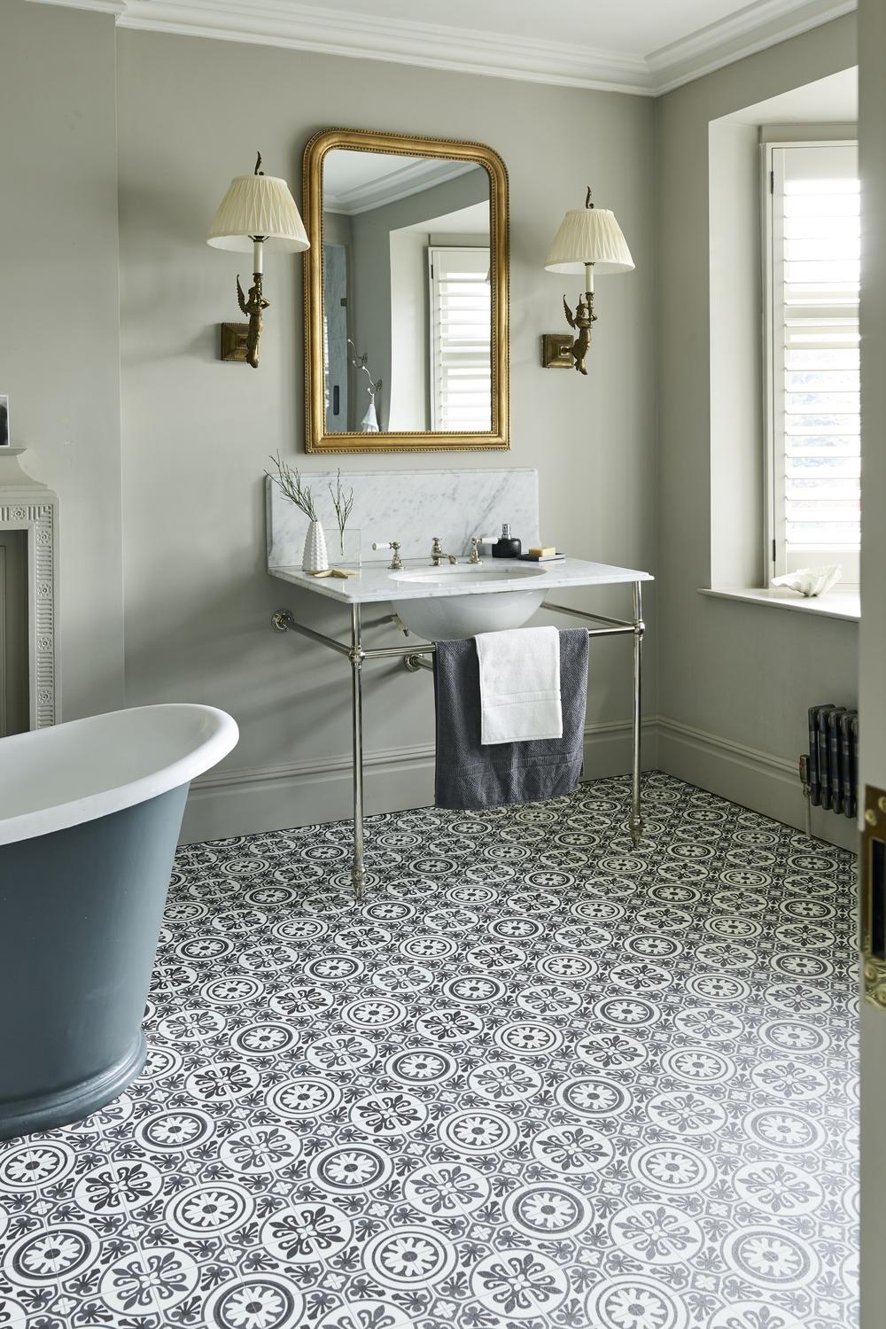 Soft gray country bathroom with elegant fixtures and cozy lighting