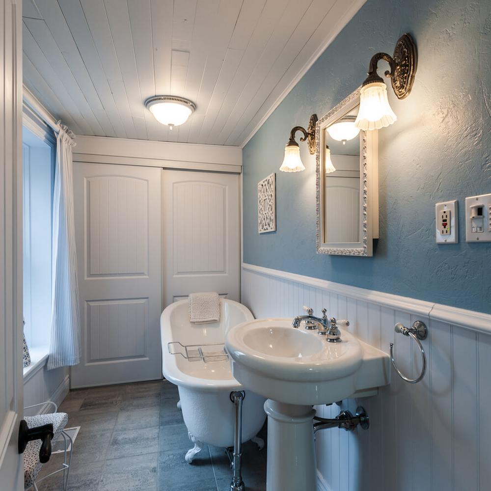 Charming country bathroom decorated with vintage elements and soft blue hues