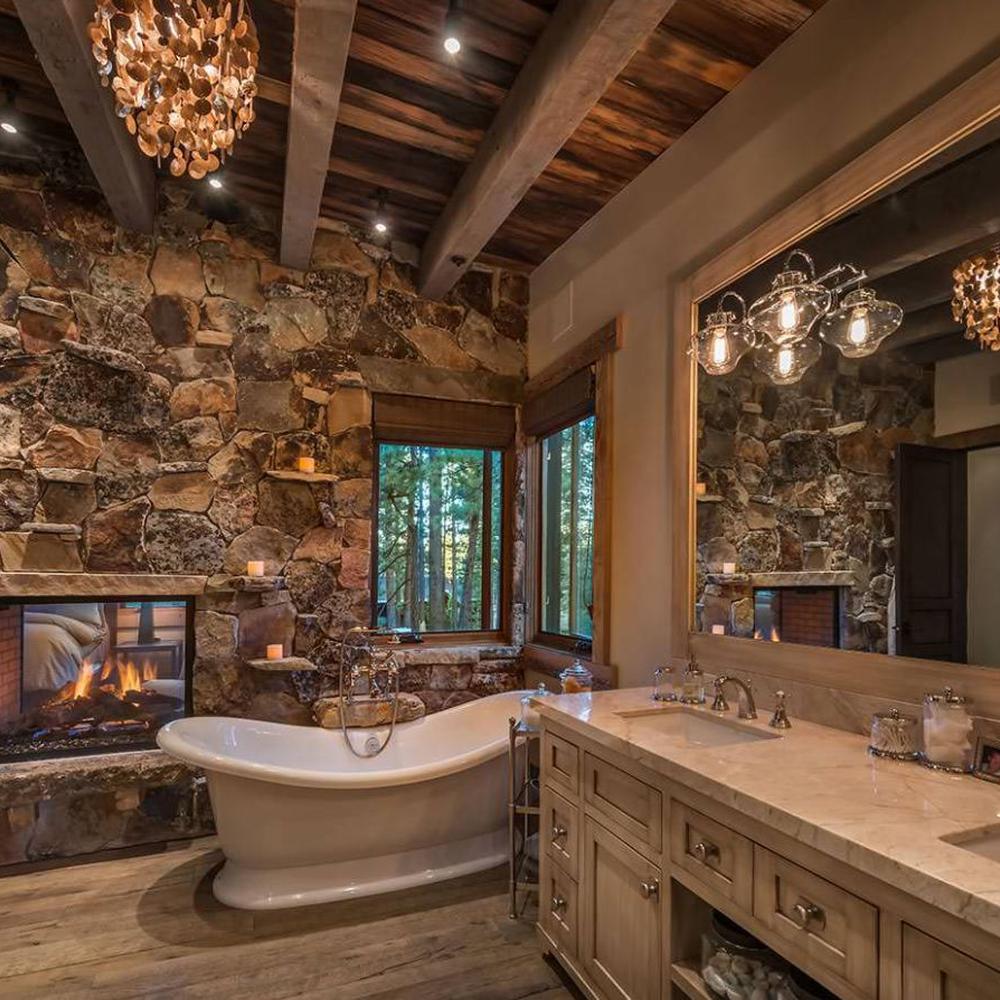 Rustic bathroom design featuring stone walls and modern elegant touches