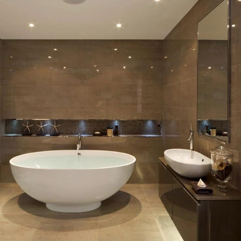 Modern bathroom featuring a freestanding bathtub and dark brown tiled walls.