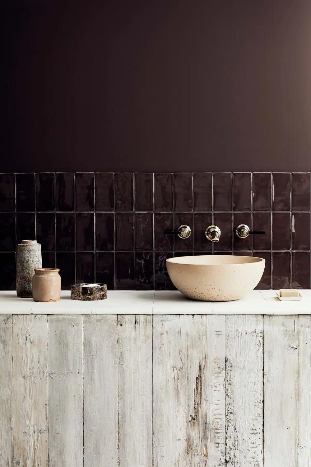 Modern bathroom with rich dark brown colors and elegant stone textures.