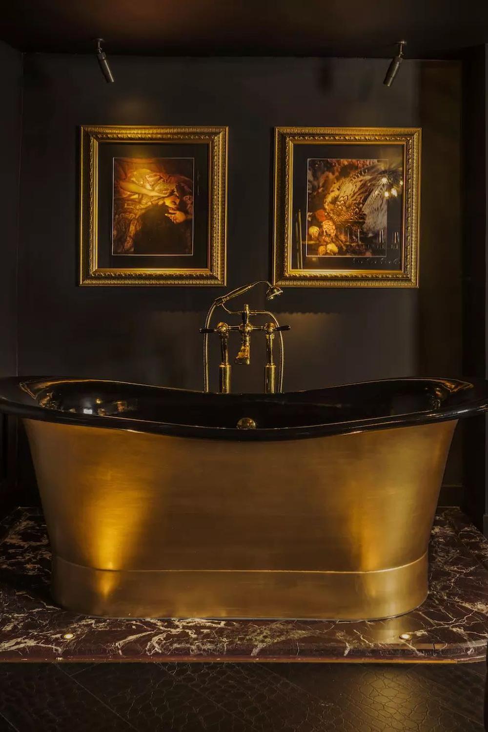 Luxurious bathroom showcasing dark brown and gold tones with elegant accessories.